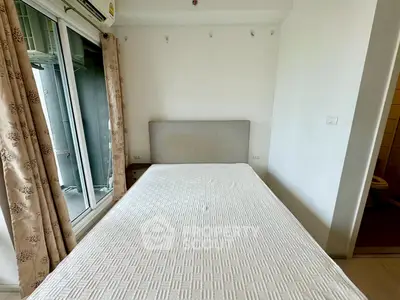 Cozy bedroom with large window and air conditioning, perfect for comfortable living.