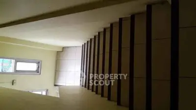 Modern staircase with sleek design and natural light in a contemporary building.