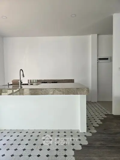 Modern kitchen with sleek island and stylish flooring