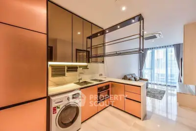 Modern kitchen with sleek copper cabinets and integrated appliances in a stylish apartment.