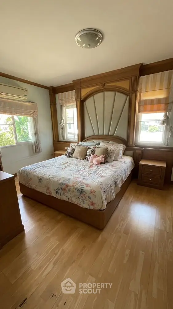 Spacious bedroom with elegant wooden furnishings and natural light
