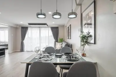 Modern dining area with elegant decor and natural light in open-plan living space
