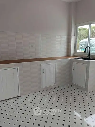 Modern kitchen with sleek white cabinets and stylish tile flooring