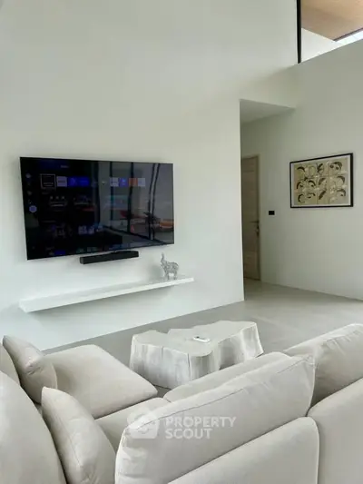 Modern living room with sleek TV setup and stylish decor in a contemporary home.