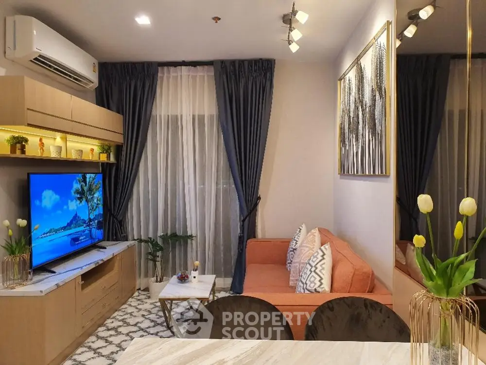 Luxurious modern living room with elegant decor and large TV, perfect for relaxation and entertainment.