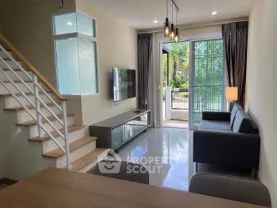 Modern living room with sleek design, open layout, and large windows overlooking a lush garden.