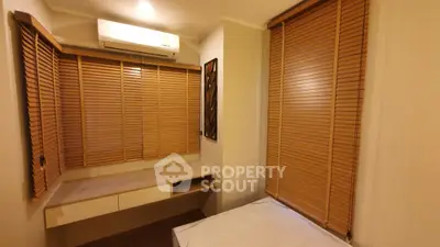Cozy bedroom with wooden blinds and built-in desk