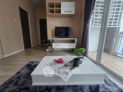Modern living room with stylish decor and balcony view