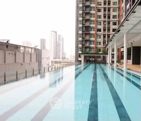 Luxurious high-rise building with stunning rooftop pool and city view.