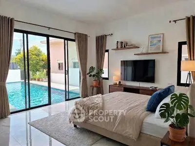 Luxurious bedroom with pool view and modern decor