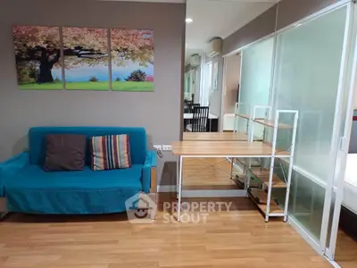 Modern living room with vibrant blue sofa and stylish wooden flooring