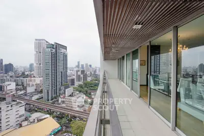 Stunning city view from a modern high-rise balcony with sleek design and panoramic skyline.