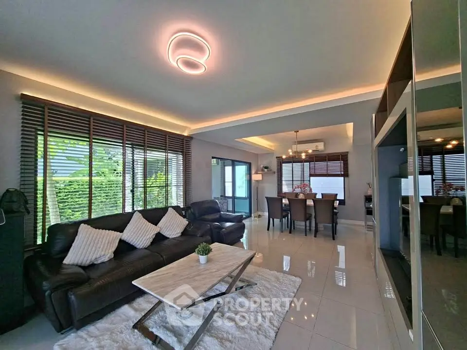 Spacious modern living room with elegant dining area and stylish lighting