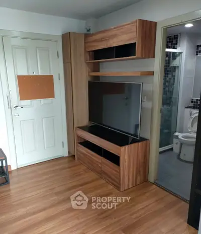 Modern living room with wooden TV cabinet and bathroom view