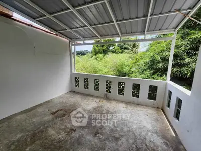 Spacious open balcony with lush green views, perfect for relaxation and outdoor enjoyment.