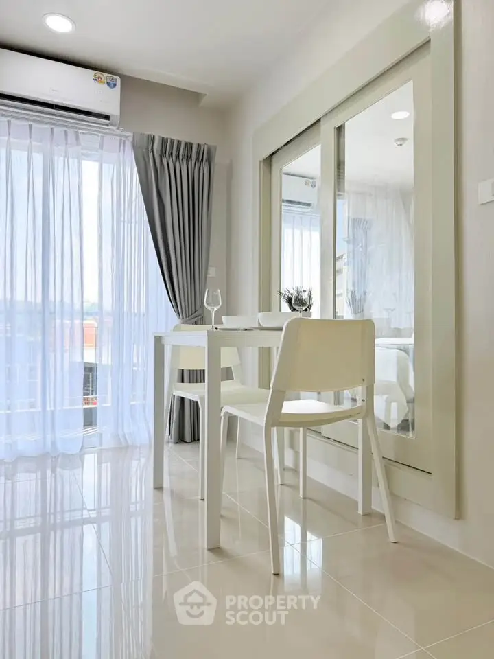 Bright dining area with modern furniture and large windows in a stylish apartment.