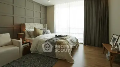 Luxurious bedroom with elegant decor and large window for natural light