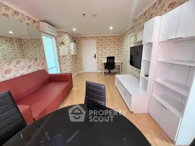 Charming living room with floral wallpaper, red sofa, and modern furniture in cozy apartment.