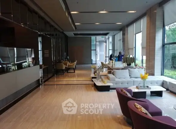 Luxurious modern living room with elegant decor and large windows offering natural light.