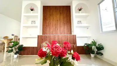 Elegant living room with modern decor and vibrant floral arrangements
