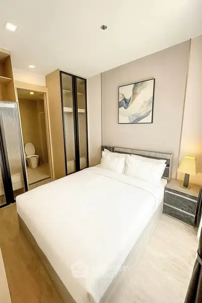 Modern bedroom with ensuite bathroom in stylish apartment