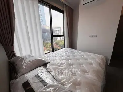Modern bedroom with large window offering city view, featuring cozy bed and air conditioning.