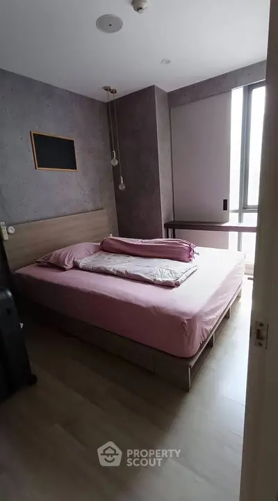 Cozy bedroom with modern decor and large window for natural light