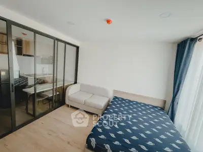 Modern bedroom with glass partition and cozy furnishings in a stylish apartment