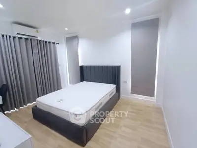 Spacious bedroom with modern design and ample natural light.