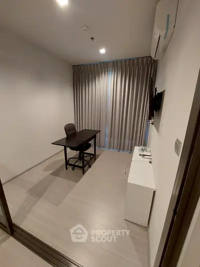 Modern study room with desk, chair, and wall-mounted TV in minimalist style.