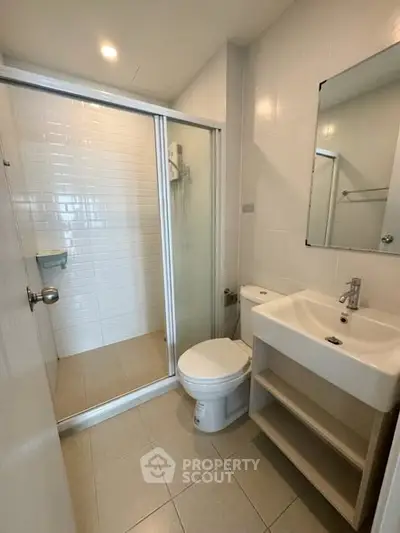 Modern bathroom with glass shower and sleek fixtures