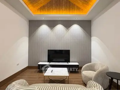 Modern living room with stylish ceiling lighting and elegant furniture