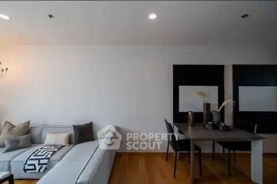 Modern living room with sleek furniture and stylish decor, featuring a cozy sofa and elegant dining area.