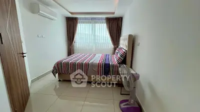 Modern bedroom with stylish decor and natural light, featuring a comfortable bed and air conditioning.