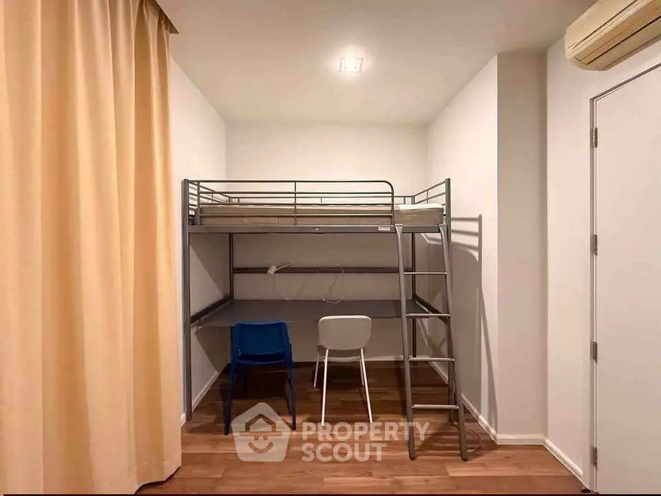 Modern bedroom with loft bed and study area, featuring wooden flooring and minimalist design.