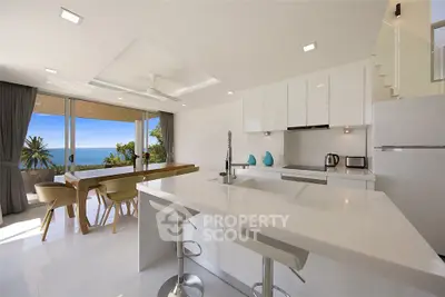 Luxurious open-plan kitchen with ocean view and modern decor