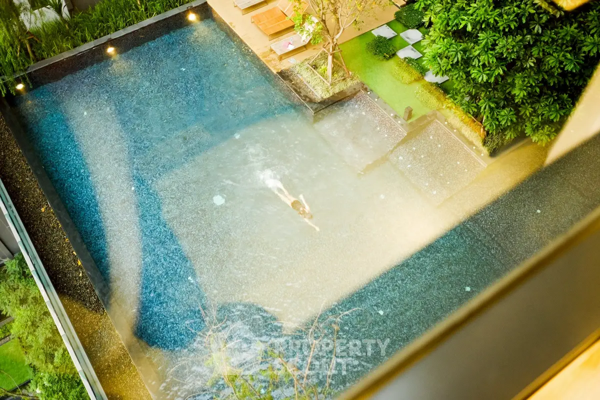 Luxurious rooftop pool with lush greenery and modern design, perfect for relaxation and leisure.