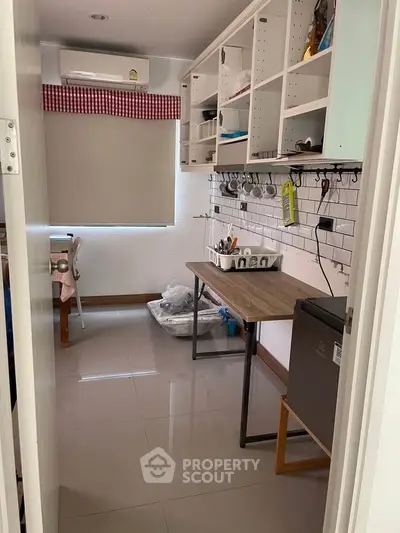 Cozy kitchen with modern open shelving and sleek appliances, perfect for culinary enthusiasts.