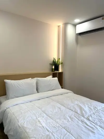 Cozy bedroom with modern air conditioning and elegant bedding
