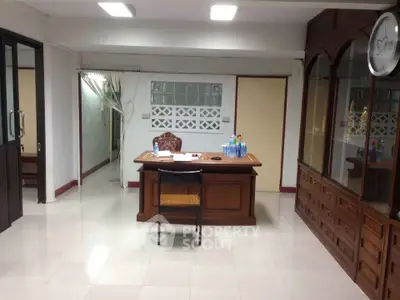 Spacious office interior with elegant wooden desk and chair, ideal for professional workspace.
