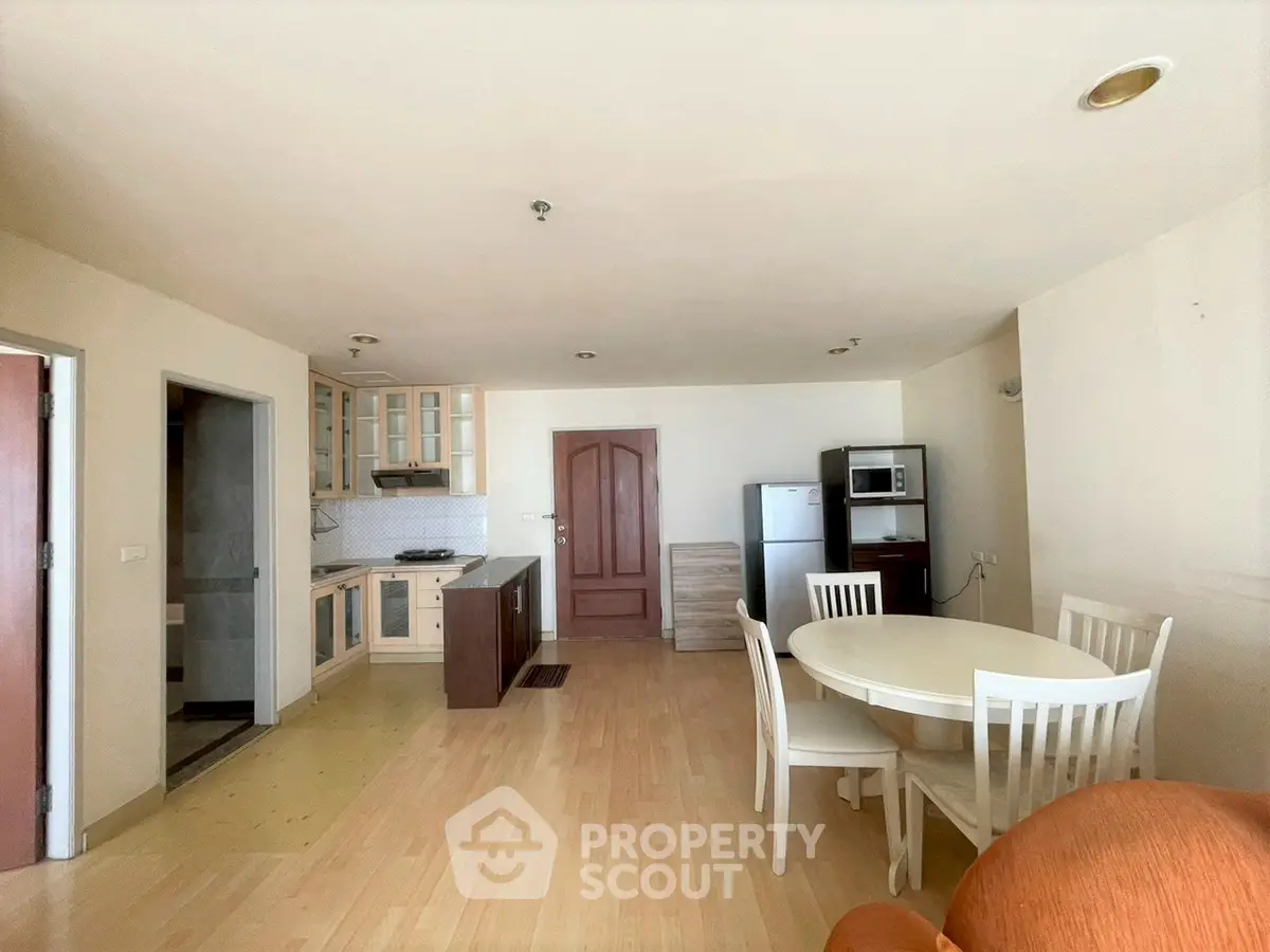 Spacious open-plan kitchen and dining area with modern appliances and wooden flooring.