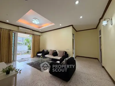 Spacious living room with modern furniture and large windows for natural light.