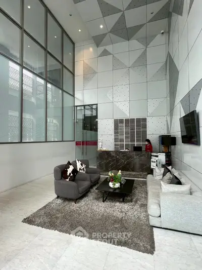 Modern lobby with stylish furniture and geometric wall design