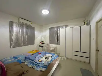Cozy bedroom with modern wardrobe and air conditioning, perfect for restful nights.