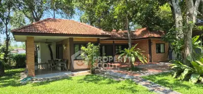 Charming brick house with lush garden and tiled roof in serene setting