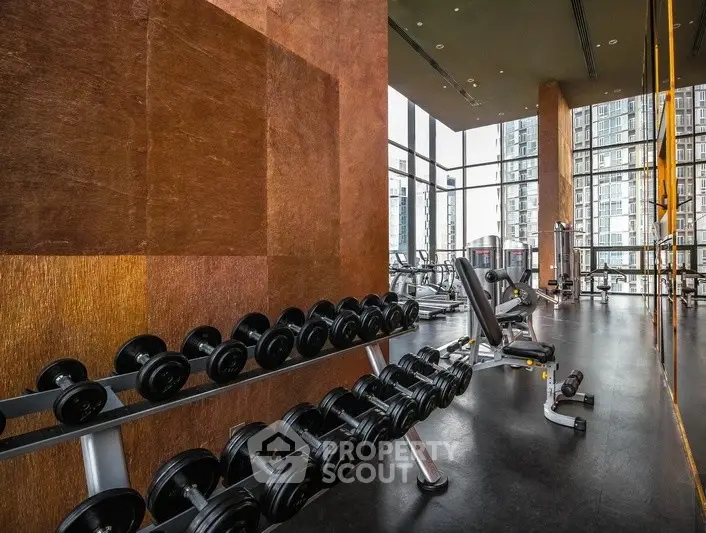 Luxurious high-rise gym with modern equipment and stunning city views.