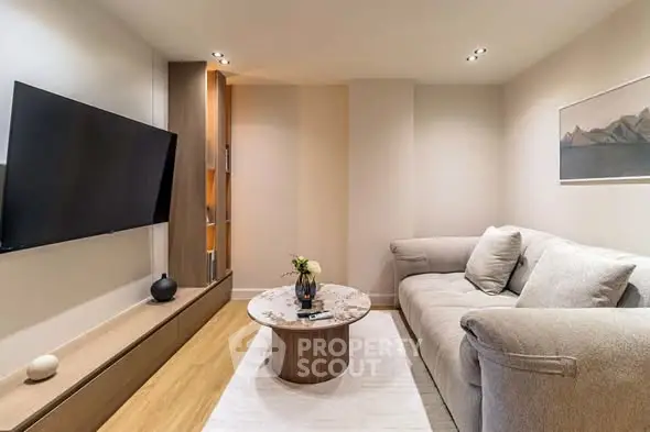 Cozy modern living room with plush sofa and wall-mounted TV