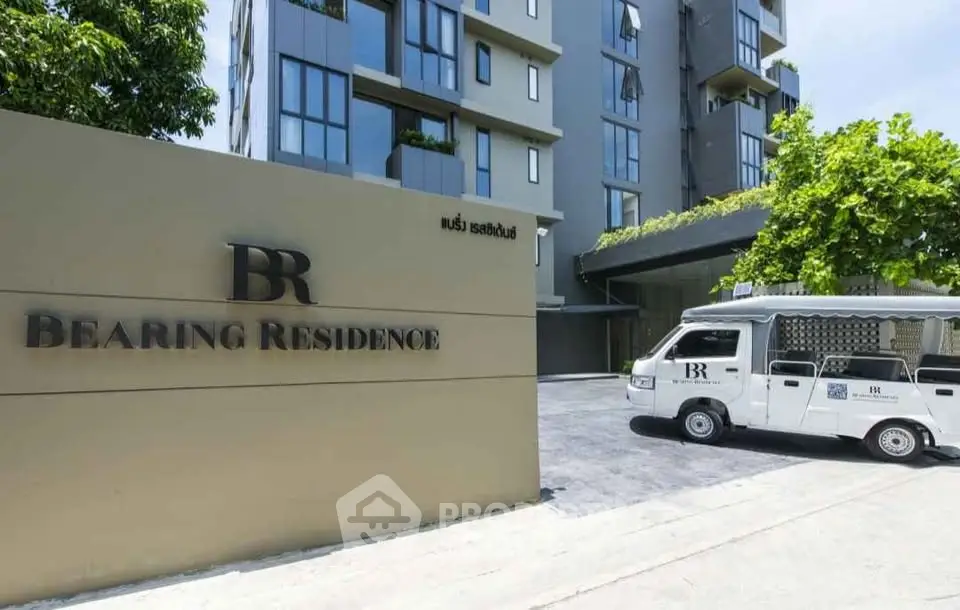 Modern apartment building exterior with branded shuttle van at Bearing Residence entrance.