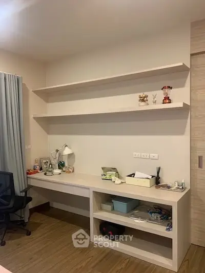 Modern study room with built-in desk and shelves, perfect for productivity.