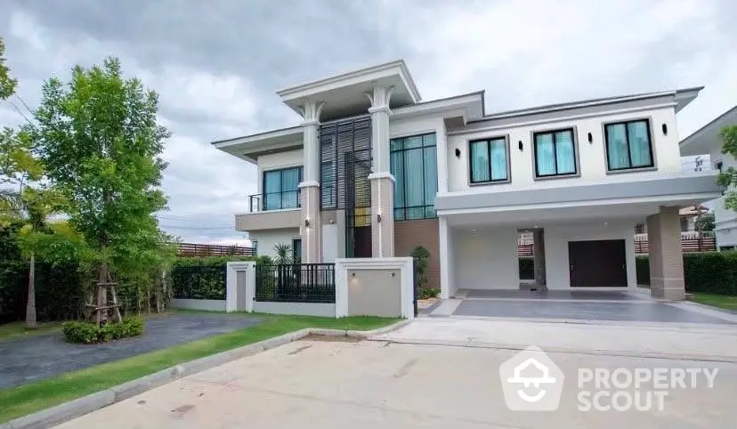 Modern two-story house with spacious driveway and lush greenery